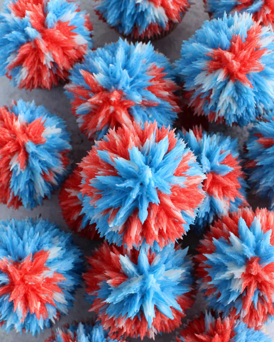 Easy fireworks cupcakes with red, white, and blue frosting in a starburst design