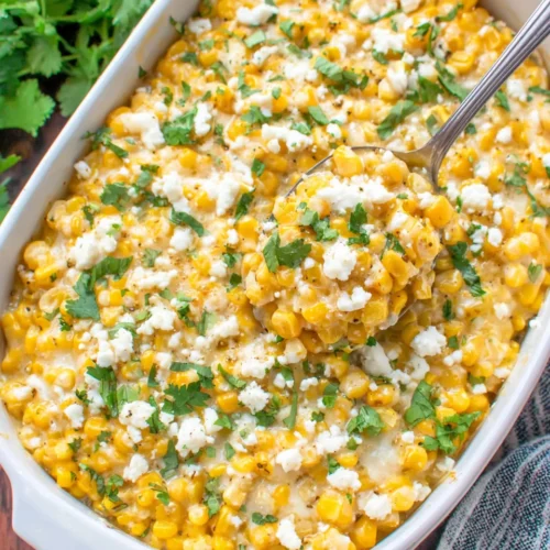 Easy Mexican Corn Dish: A Creamy Delight for Everyone 1 Creamy easy Mexican corn dish with cheese and cilantro in a white baking dish