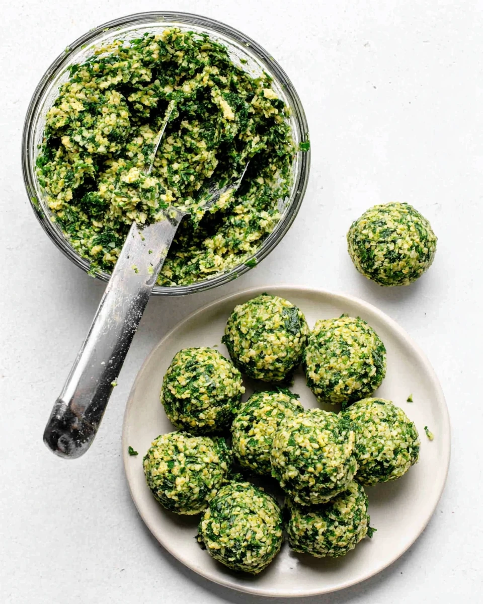 Fresh green falafel balls on a white plate beside a bowl of falafel mixture with a scoop