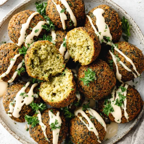 Crispy homemade falafel balls with tahini sauce and fresh parsley