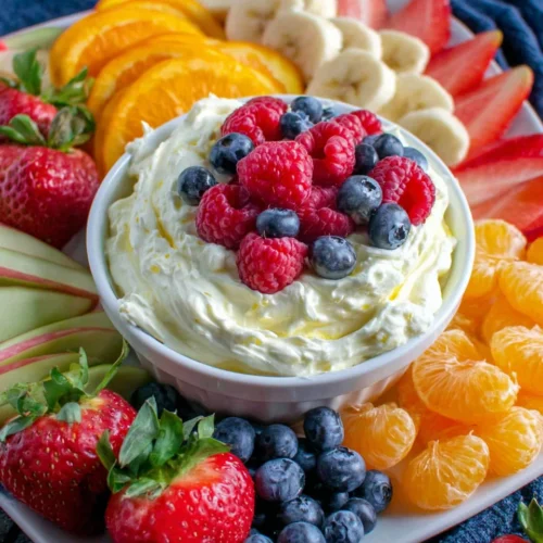 Lemon whip fruit dip served with fresh fruits like strawberries, apples, and blueberries