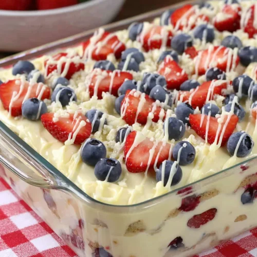 No bake summer berry icebox cake with strawberries, blueberries, and white chocolate drizzle