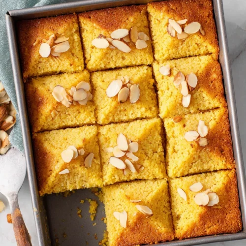 Nutty golden cake with crunchy almond topping in a baking pan
