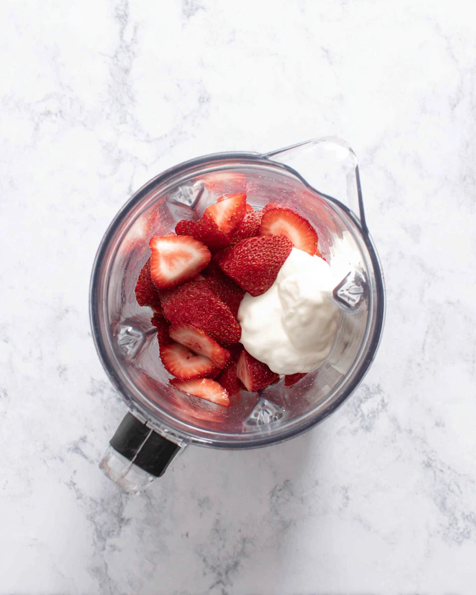 Strawberry smoothie recipe with yogurt ingredients in blender