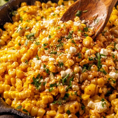 Street Corn Off the Cob: A Flavorful Delight 1 Street corn off the cob with cotija cheese and herbs in a skillet