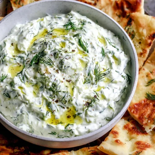 Creamy vegan tzatziki with fresh dill and pita bread