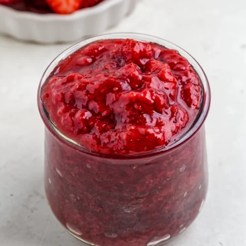 3-ingredient strawberry preserves in a glass jar with fresh strawberries