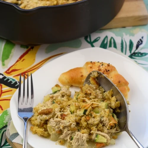 Chicken stuffing casserole with mixed vegetables in a skillet and on a plate