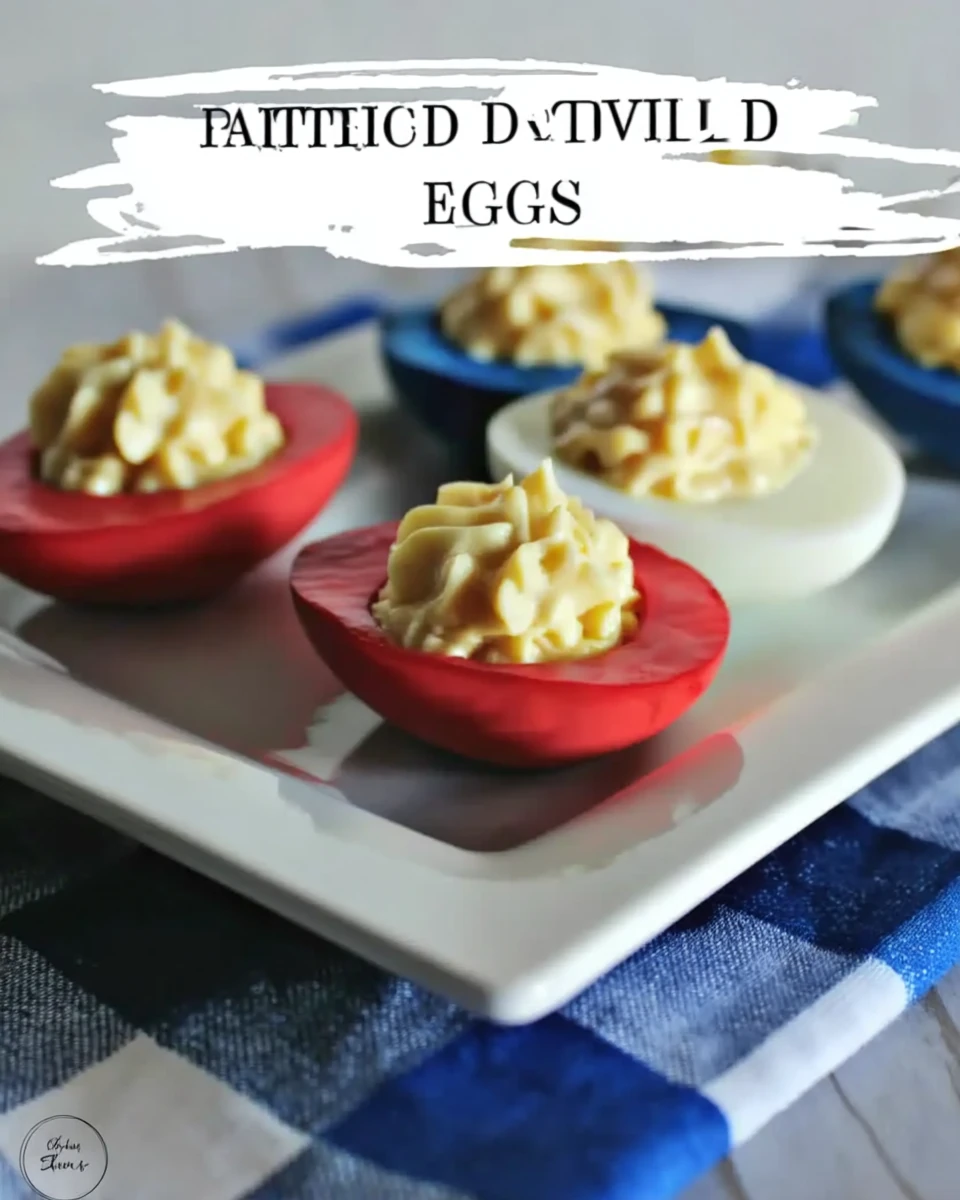 Colorful deviled eggs with red and blue dyed whites and creamy filling on a white plate