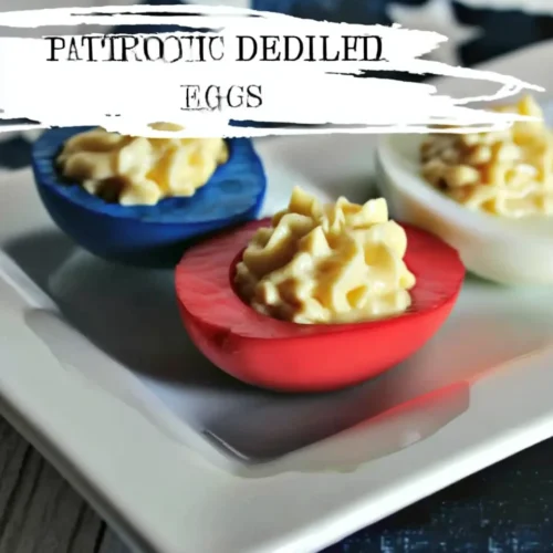 Colorful deviled eggs with red and blue dyed whites and creamy filling on a white plate