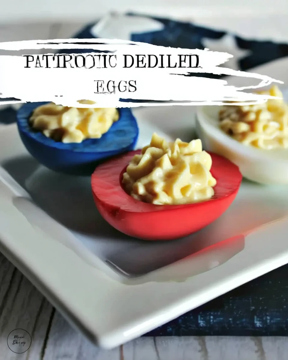 Colorful deviled eggs with red and blue dyed whites and creamy filling on a white plate