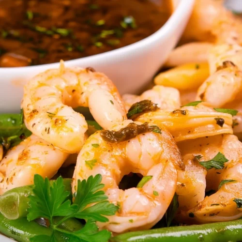 Shrimp and green beans with seafood boil sauce, garnished with fresh parsley