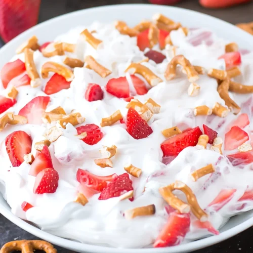 Strawberry pretzel fluff salad with fresh strawberries and crunchy pretzels on top