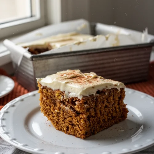 Cinnamon Cream Cheese Frosting: A Delightfully Sweet Indulgence 1 Pumpkin bar with cinnamon cream cheese frosting on a white plate