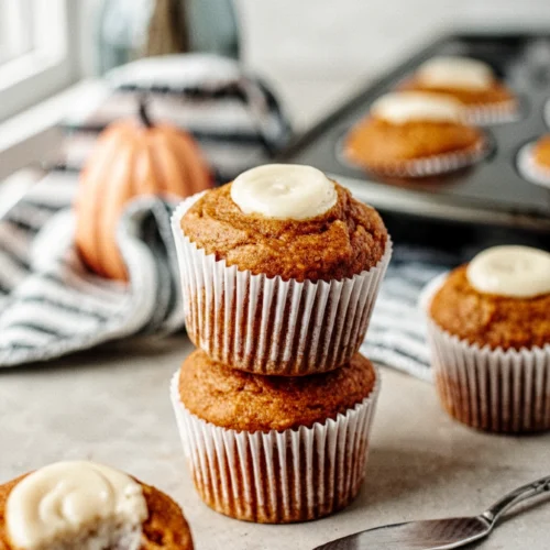 Copycat Starbucks Pumpkin Cream Cheese Muffins: Delightful and Easy 1 Copycat Starbucks pumpkin cream cheese muffins with cream cheese filling, stacked and partially eaten