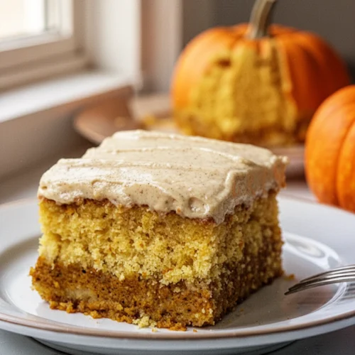 A slice of pumpkin magic cake with three layers on a white plate