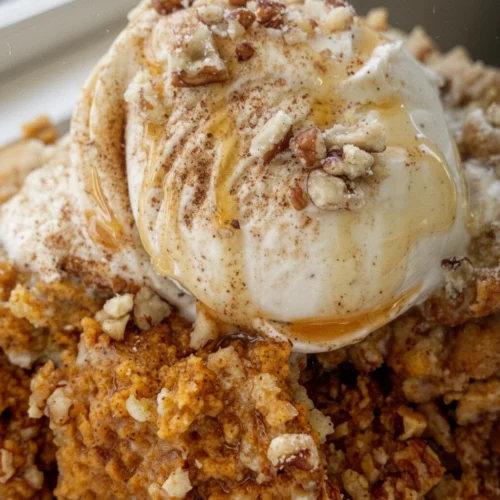 Pumpkin pie pecan cobbler with vanilla ice cream and caramel drizzle